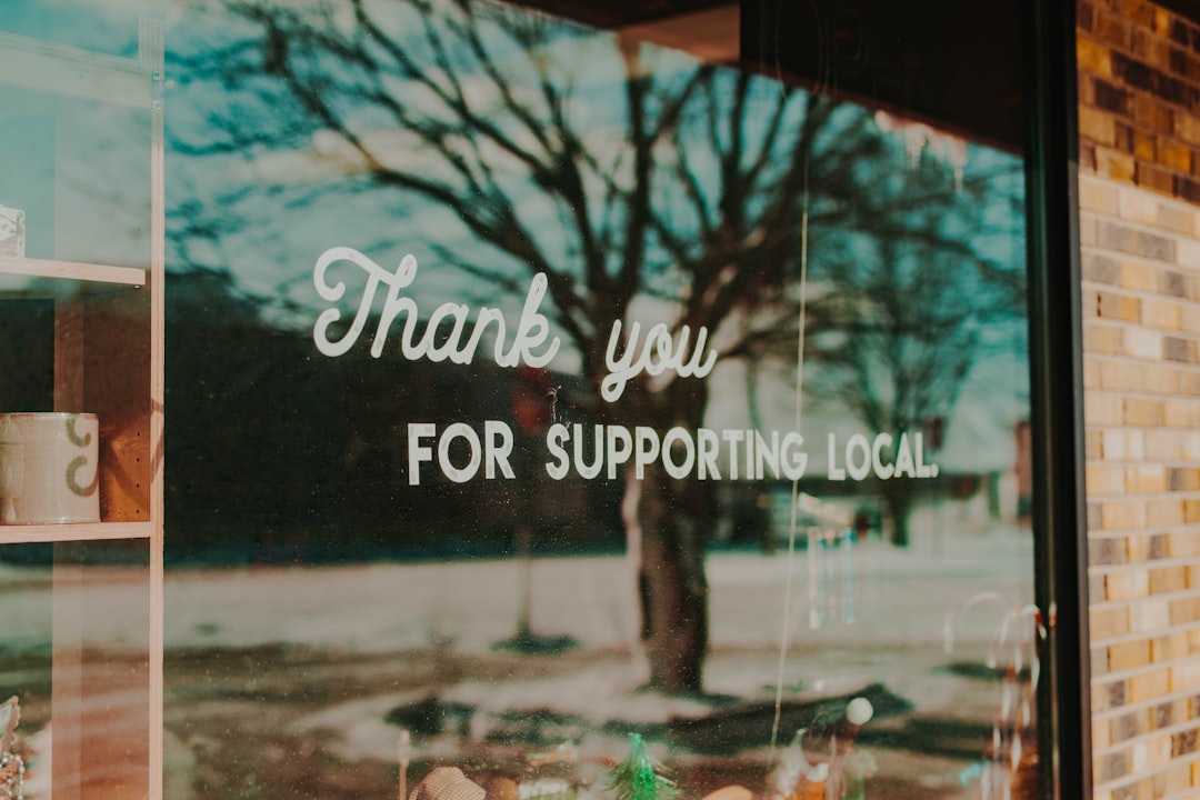 A storefront window sign reading Thank You for Supporting Local, representing Nevada small businesses