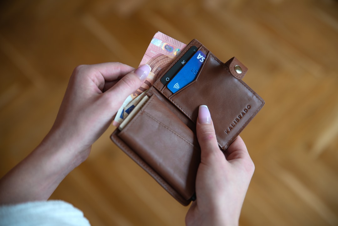 Person holding a wallet with identification, representing the documents Nevada voters will need under Question 7