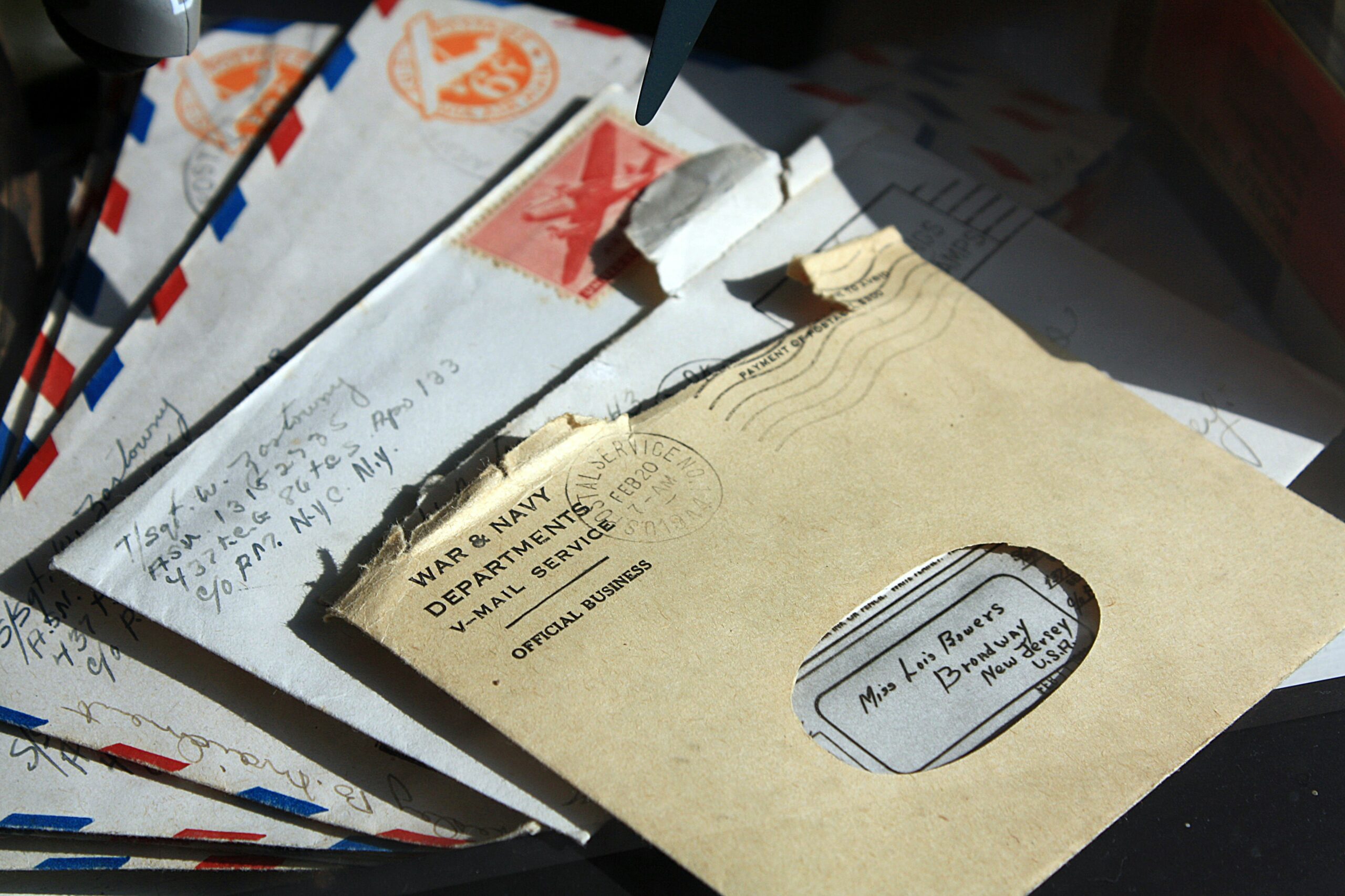 Opened envelopes on a table, representing mail ballot return envelopes and signature review