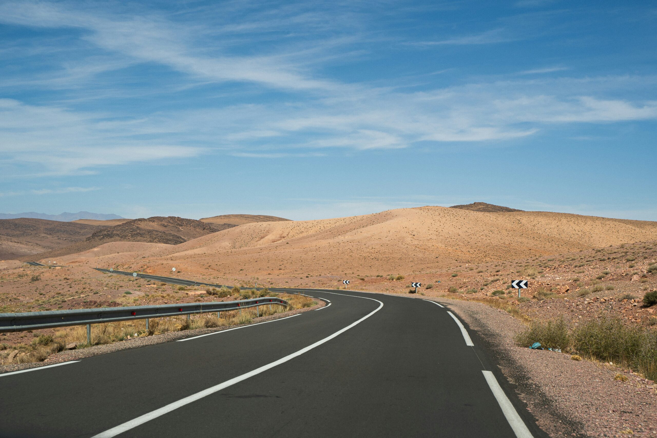 A winding highway crossing open desert in rural Nevada
