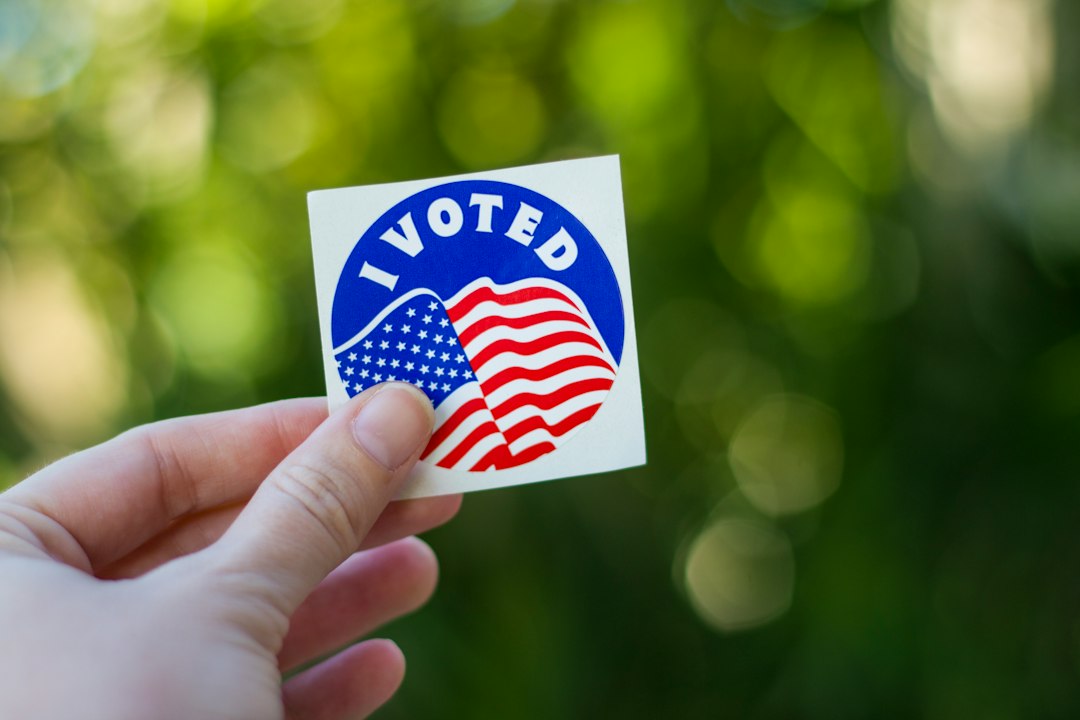 Hand holding an I Voted sticker after casting a ballot in Nevada
